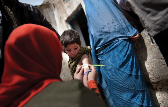 A child is examined by a UNICEF health worker to assess for malnutrition