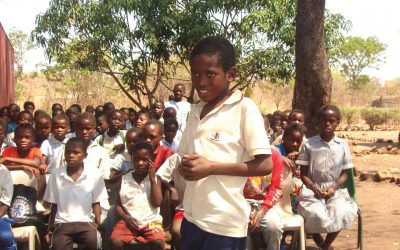 Child recites poetry from a book supplied by the Literacy in a Box charity