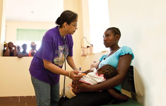 A doctor funded by the Rotary Foundation helps young mother in africa