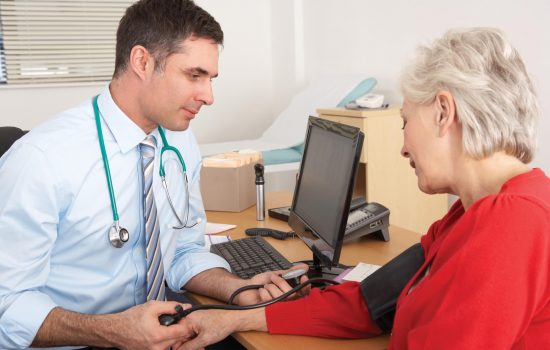 doctor checks blood pressure for stroke symptoms