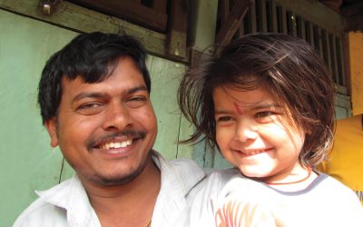 A child and her father smile after receiving polio vaccination India