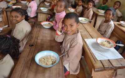 children enjoy meal at school packed by Rise Against Hunger volunteers