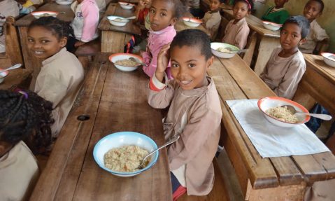 children enjoy meal at school packed by Rise Against Hunger volunteers