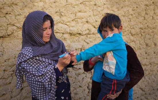 Child has finger coloured purple to indicate polio vaccination