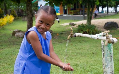 girl washes hands with clean water