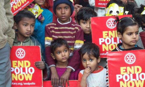 children holding a rotary end polio now sign
