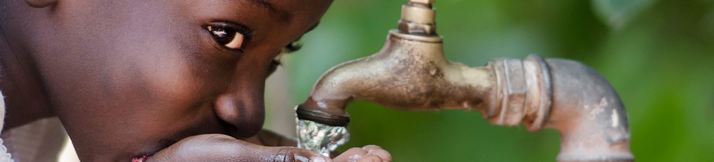 young girl drinks clean water from tap rotary foundation