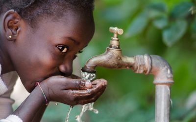 young girl drinks clean water from tap rotary foundation