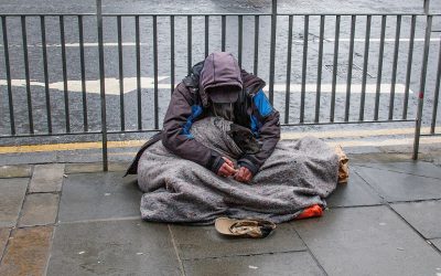 homeless man sits on street in edinburgh
