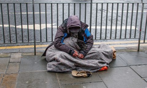 homeless man sits on street in edinburgh