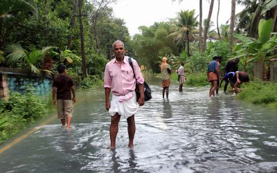 flooded roads and people walking through