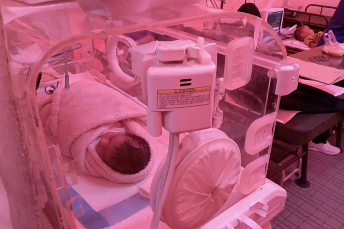 refugee camp babies wrapped up doctors help and medical support