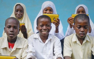 children benefitting from technology tablets for education purposes