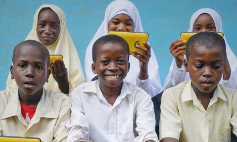 children benefitting from technology tablets for education purposes